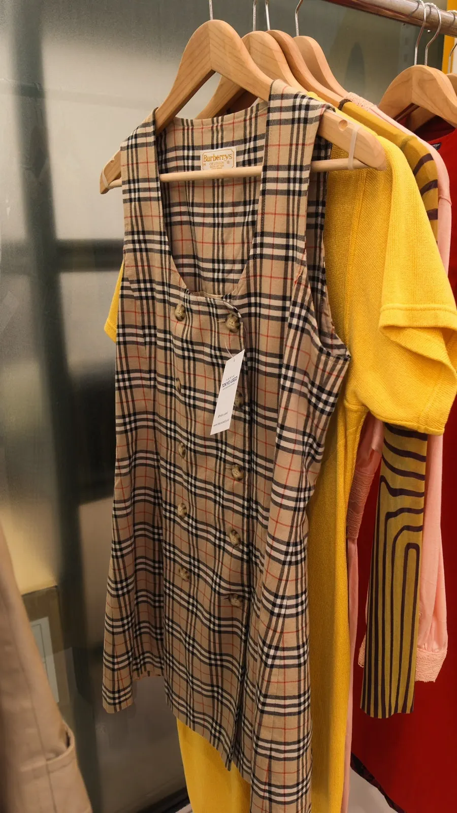 Vintage clothing racks organized by item type