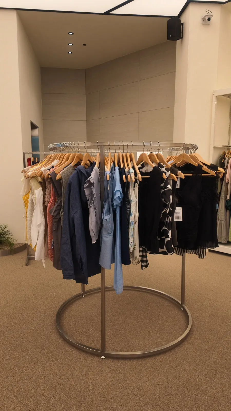Fitting room area with surrounding clothing displays