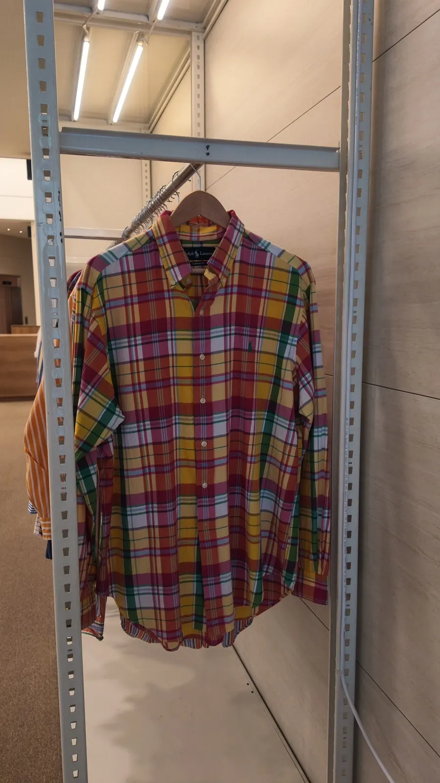 Knitwear and dresses arranged on hangers