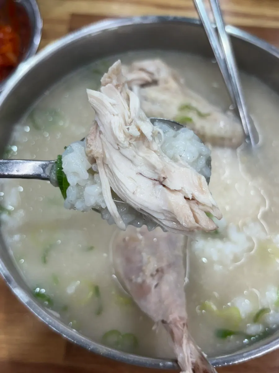 Bowl of chicken gomtang loaded with meat
