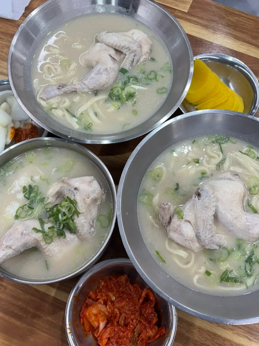 Table set with chicken kalguksu and chicken gomtang