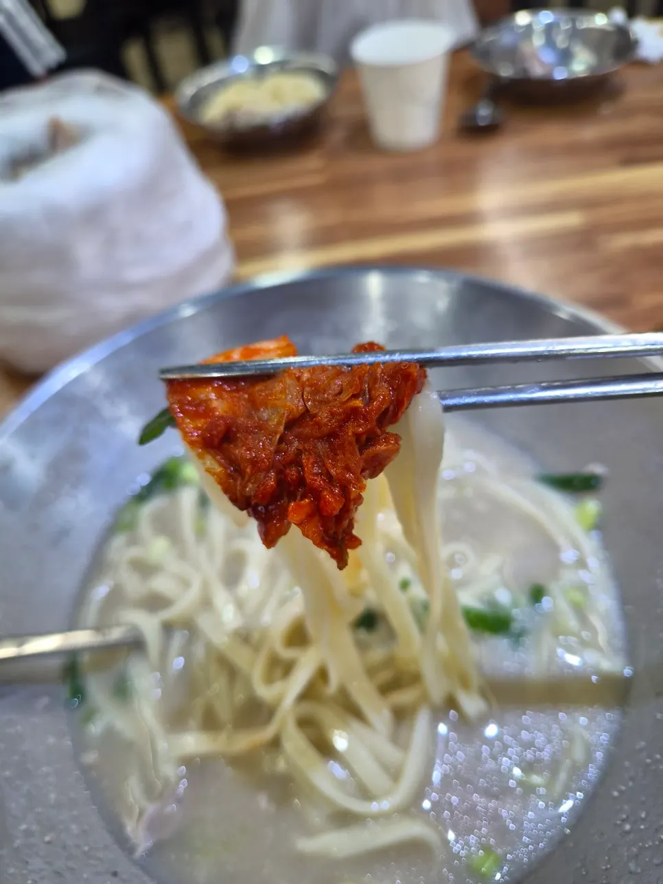 Extra spicy kimchi picked up with chopsticks