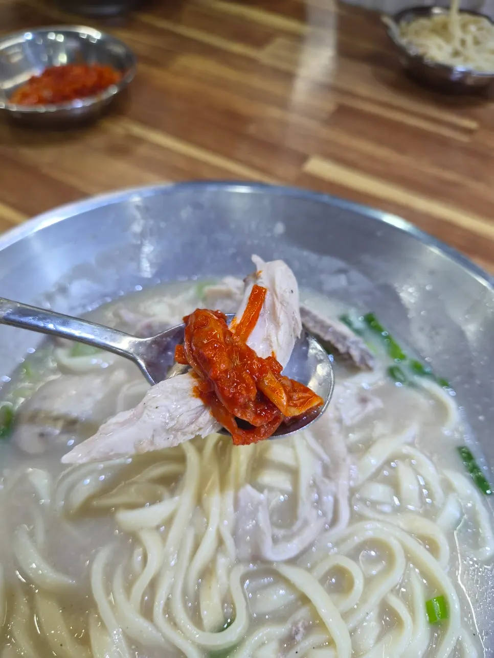 Extra spicy kimchi placed on top of kalguksu noodles