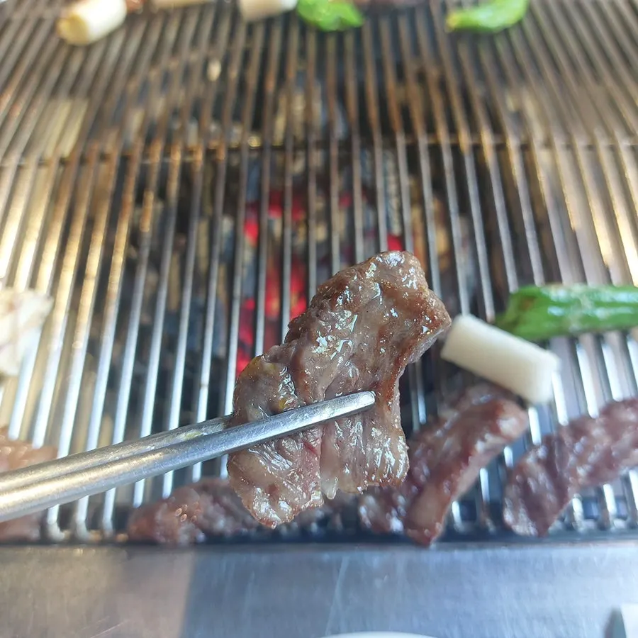 Flower short rib cooking on the grill