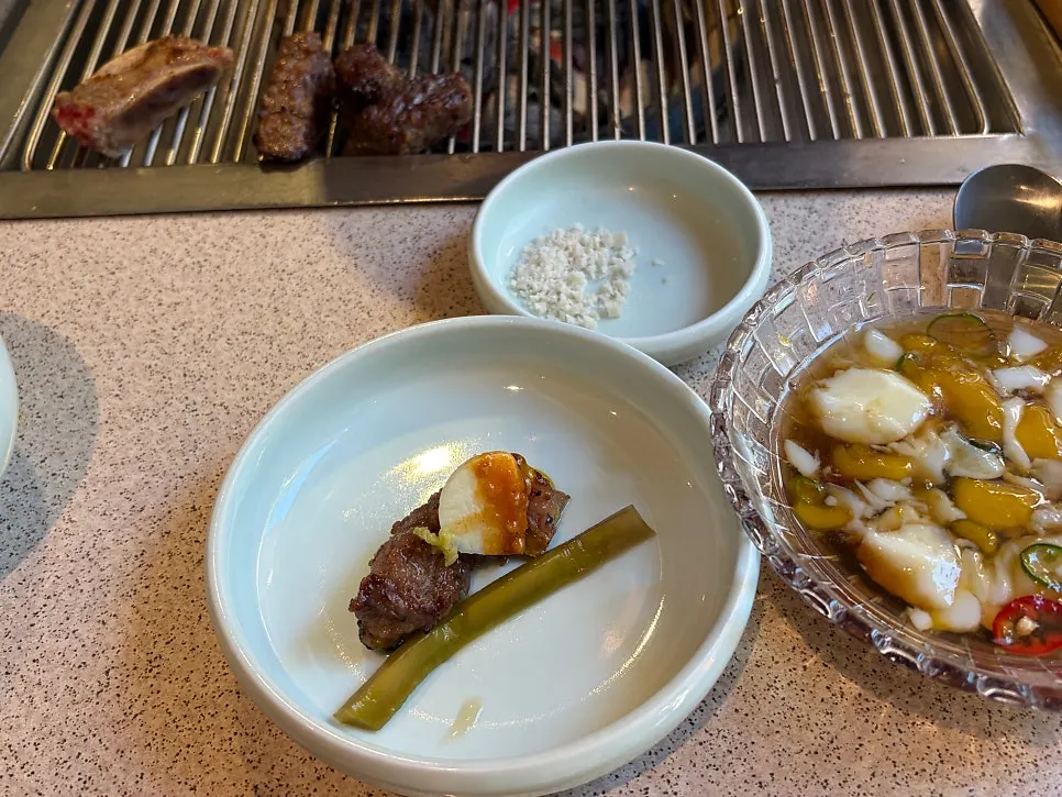 Poached egg mixed into the dipping sauce with ribs