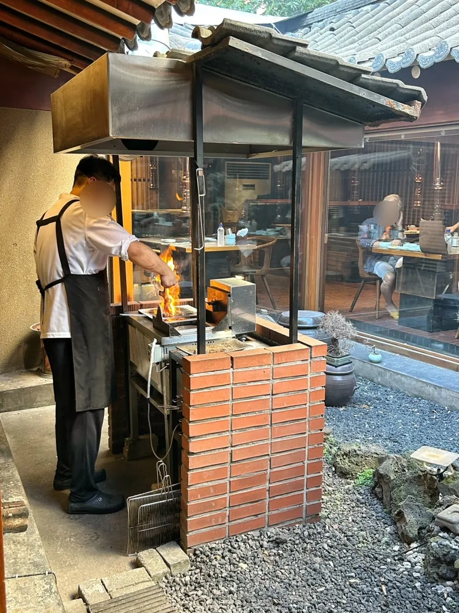 Food being carefully grilled outside