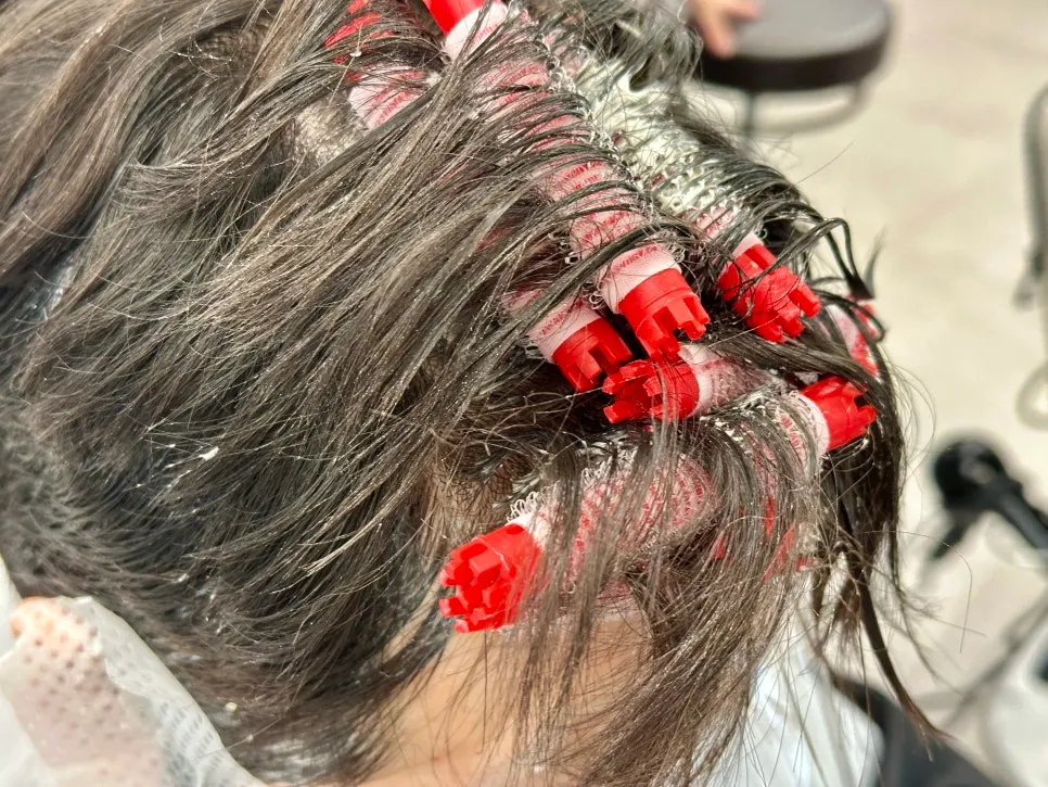 Designer personally handling the perm neutralization