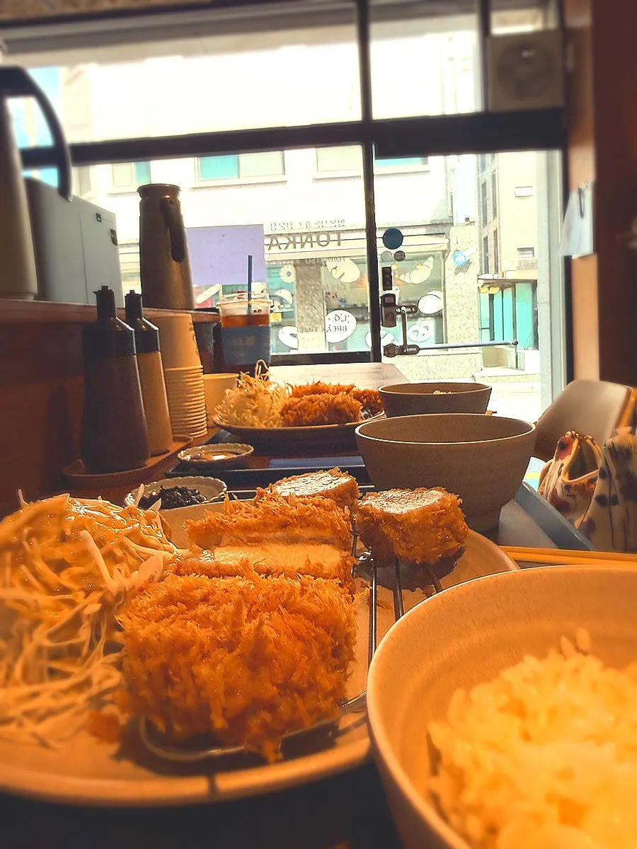 A piece of tonkatsu with sauce and salt