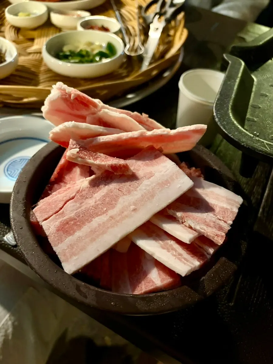 Three servings of quick-frozen pork belly on the grill