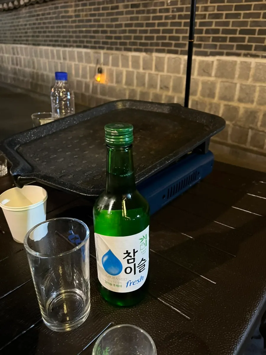 Soju glass next to the pork belly