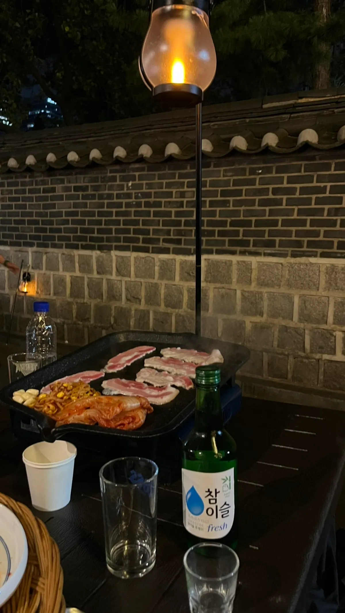 Frozen pork belly and mushrooms on the outdoor grill