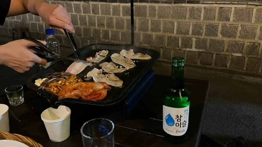 Wide shot of meat grilling on the pan