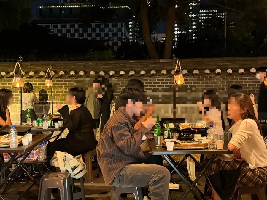 Outdoor tables lit up after sunset