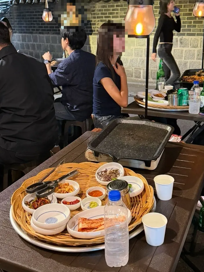 Outdoor table set with grill and basic side dishes