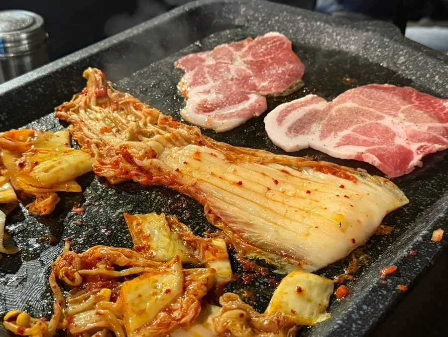 Frozen pork neck on the grill