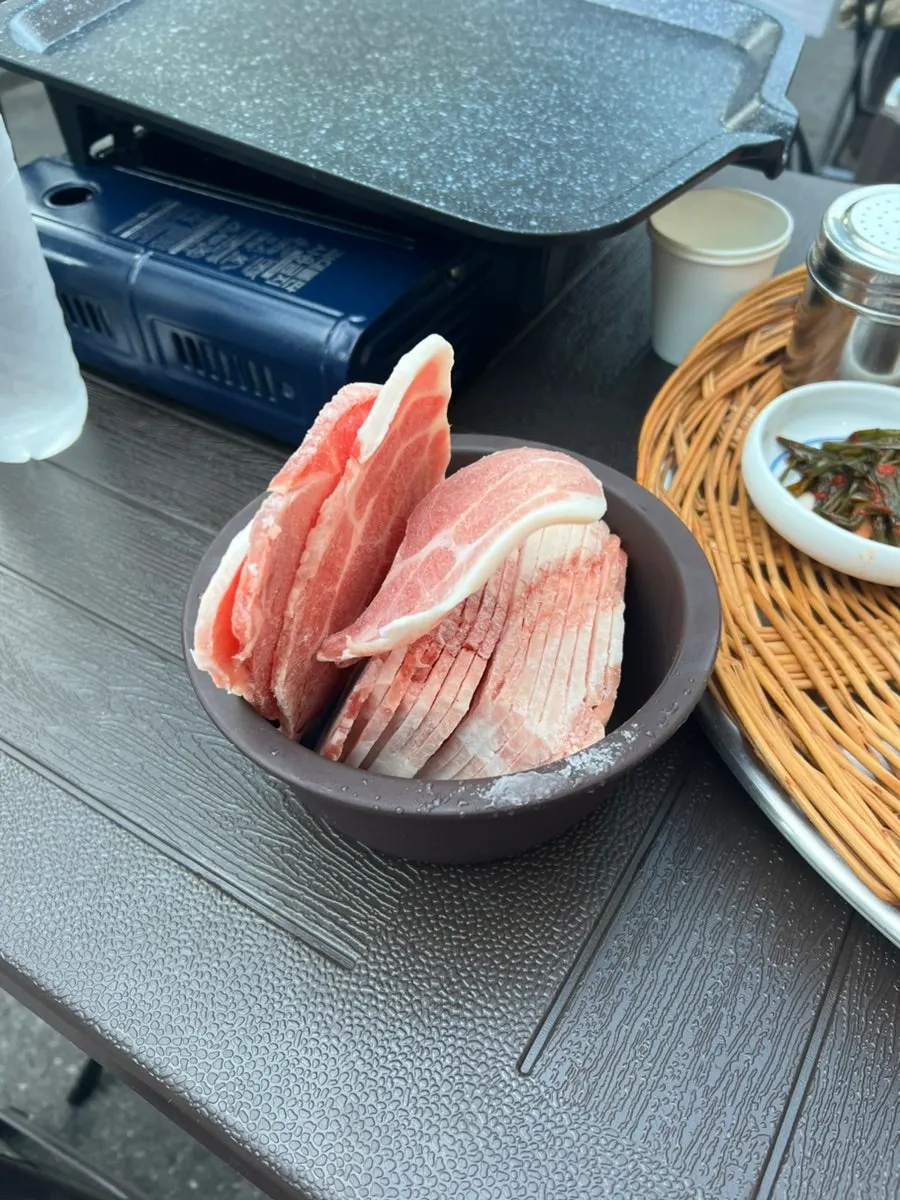 A full spread of basic banchan on a wicker tray