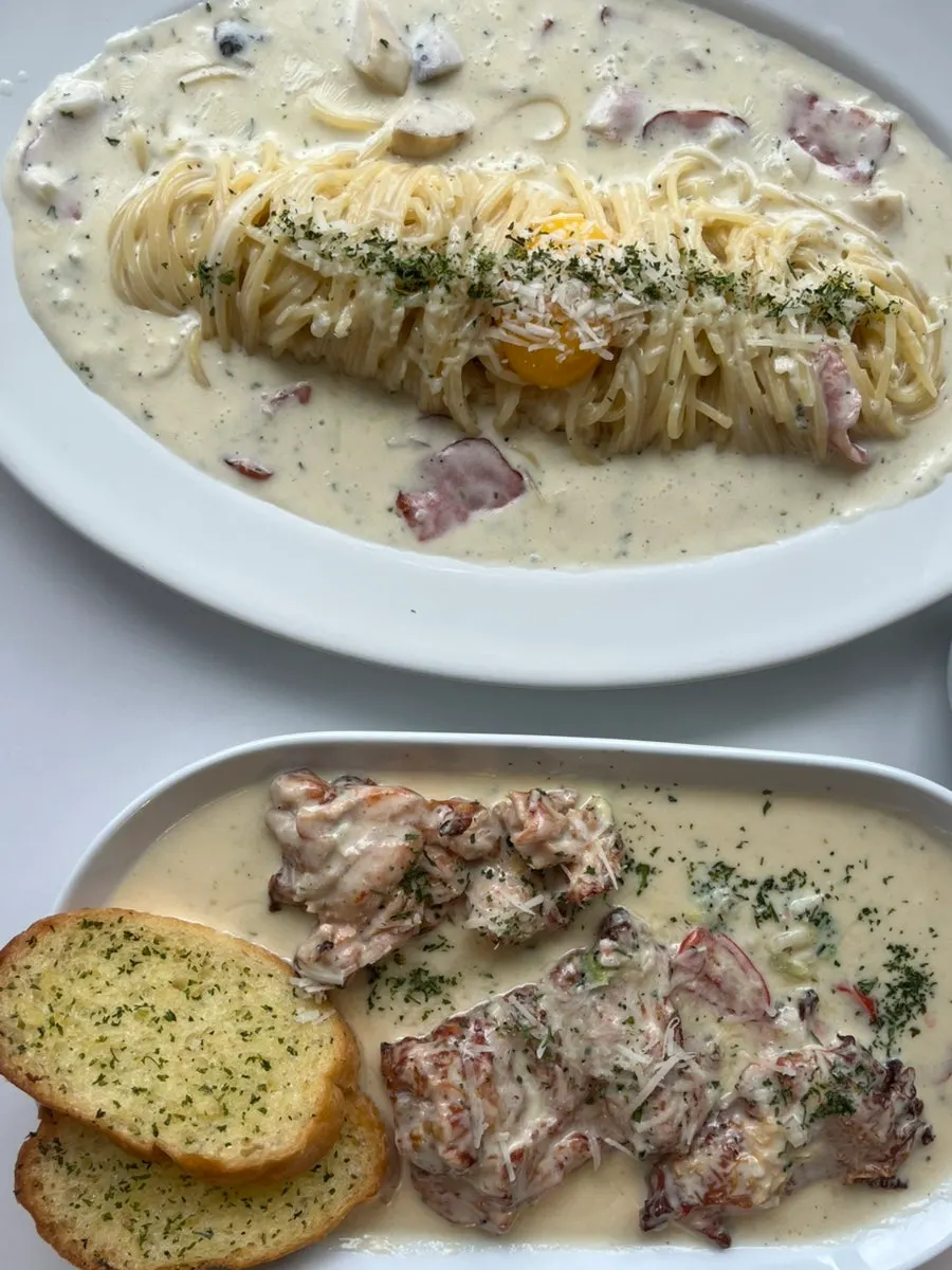 Chicken steak served with garlic bread