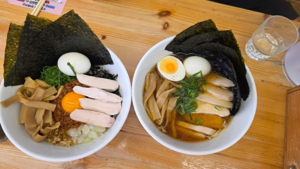 Full-topping shoyu ramen and full-topping mazesoba served on the table