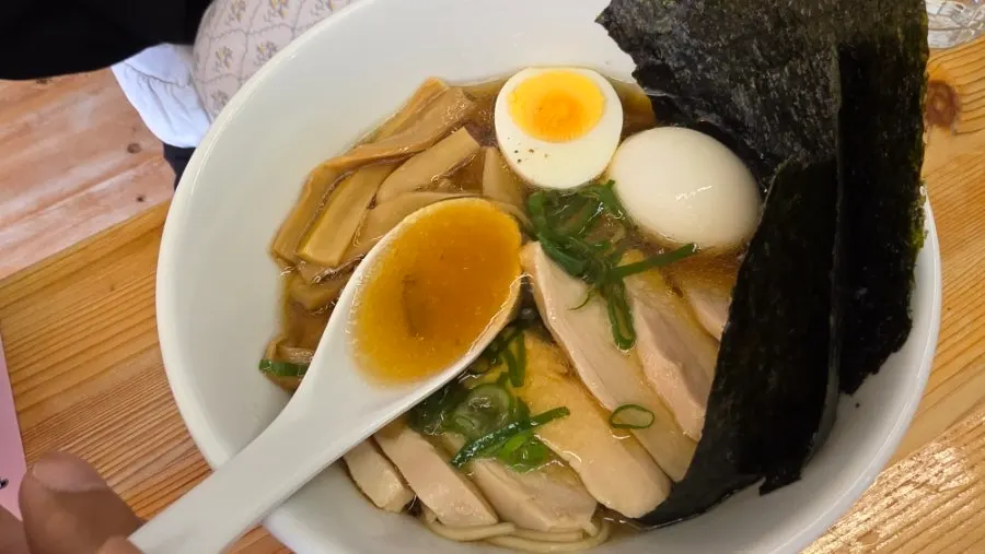 A bowl of shoyu ramen with a clean visual presentation