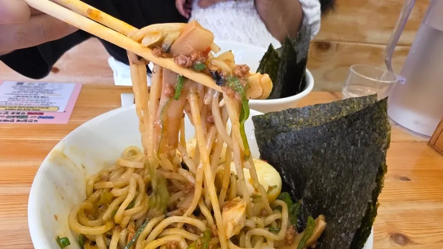 Chewy mazesoba noodles mixed with burst egg yolk