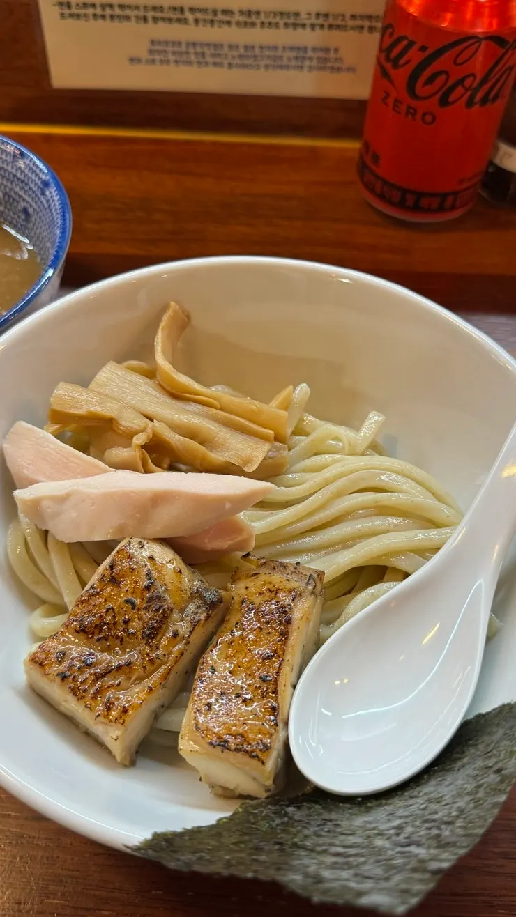 Noodles dipped into the tsukemen broth