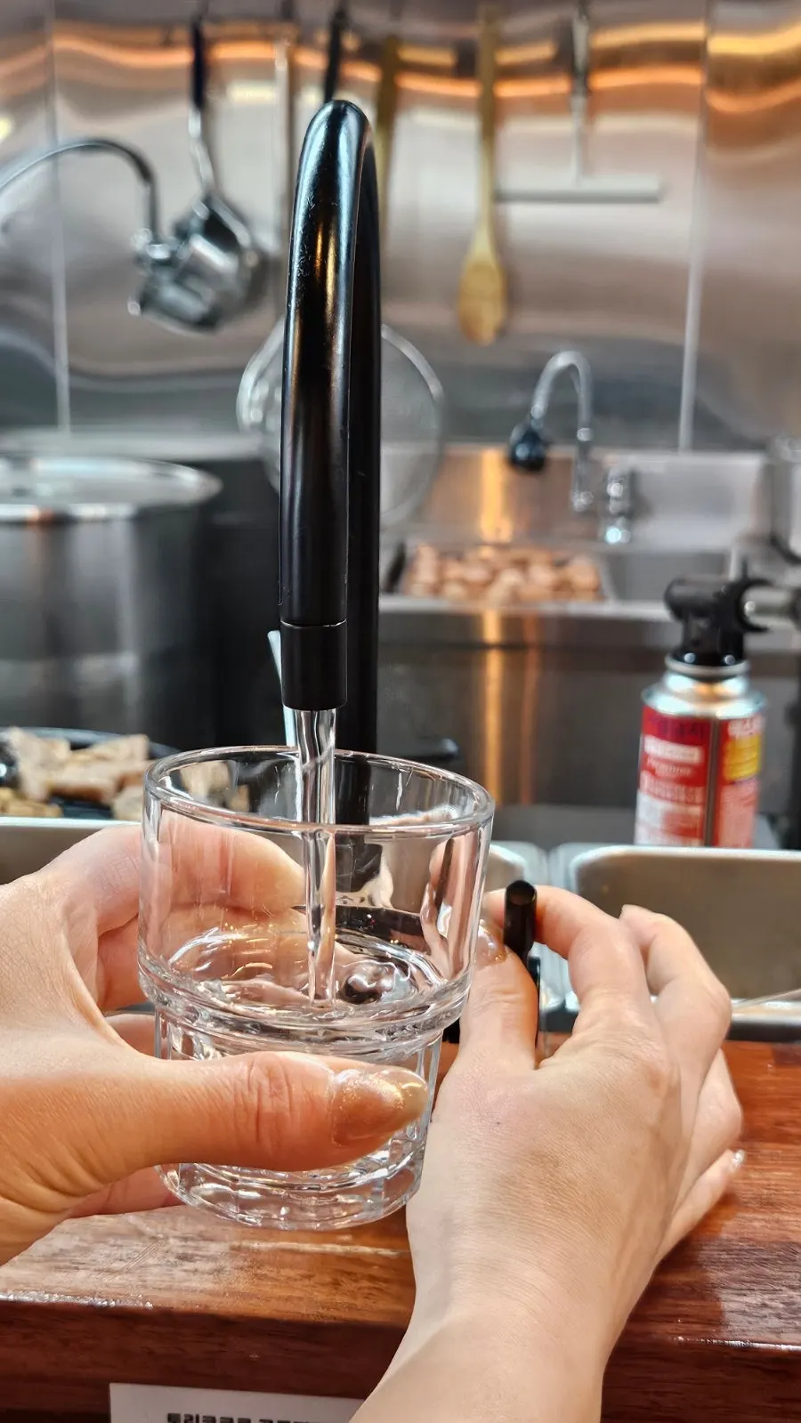 Water cup, kelp vinegar, and whole peppercorns on the table