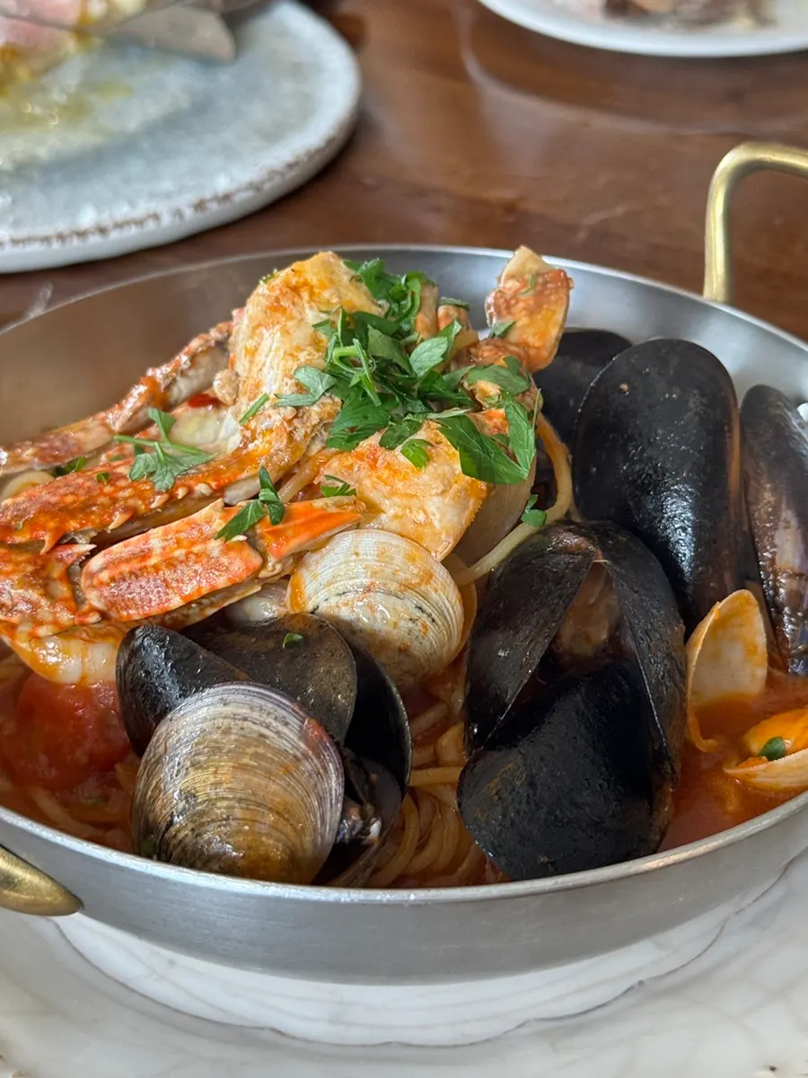 Seafood tomato pasta topped with crab and mussels