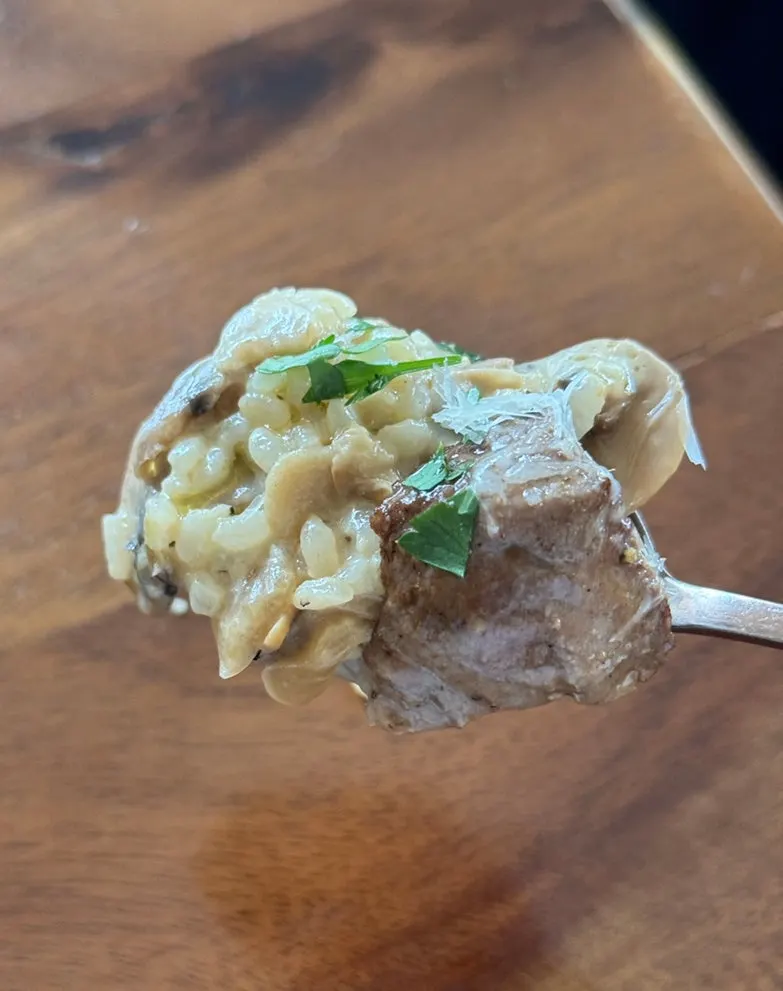 Steak porcini risotto topped with steak