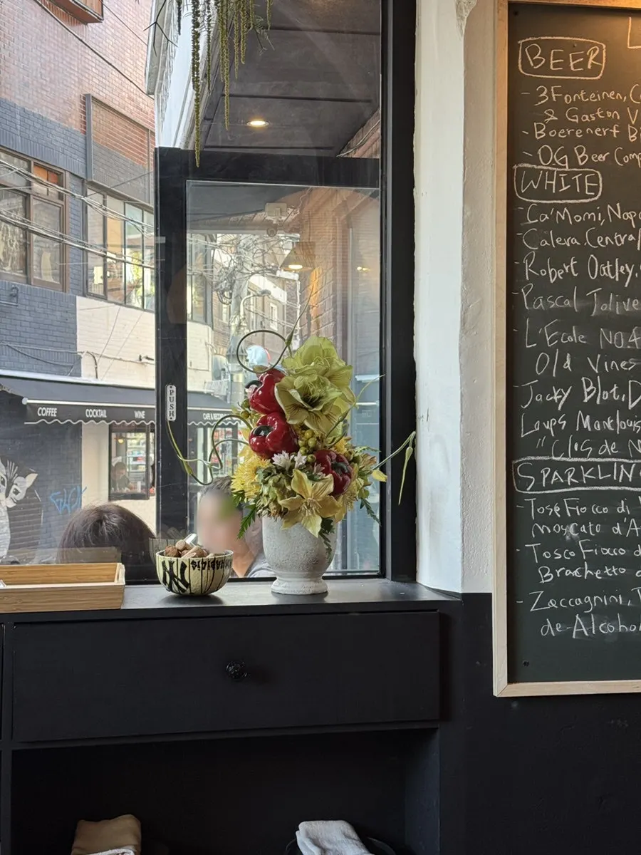 Flower arrangement in a vase by the window