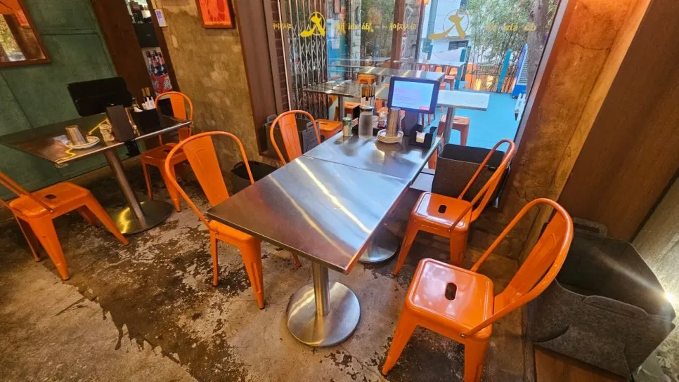 Interior of Ttasijia Yeonnam with stainless steel tables