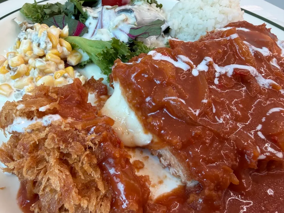 Pork cutlet plate served with salad and corn kernels