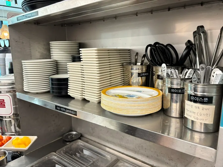 Plates and utensils laid out at the self-serve bar