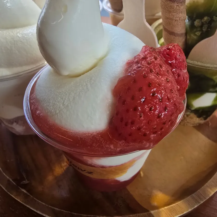 Soft serve with fresh strawberries and strawberry syrup