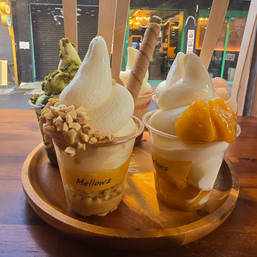 Matcha and peanut butter ice cream decorated with long cookies