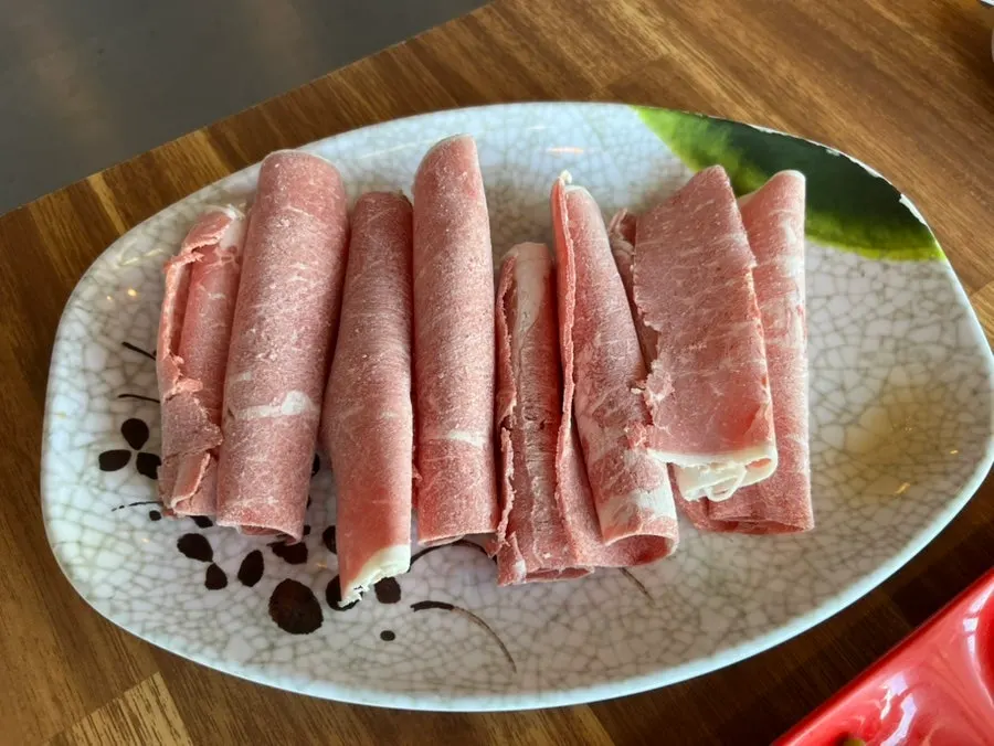 Plate of beef shabu-shabu provided complimentary