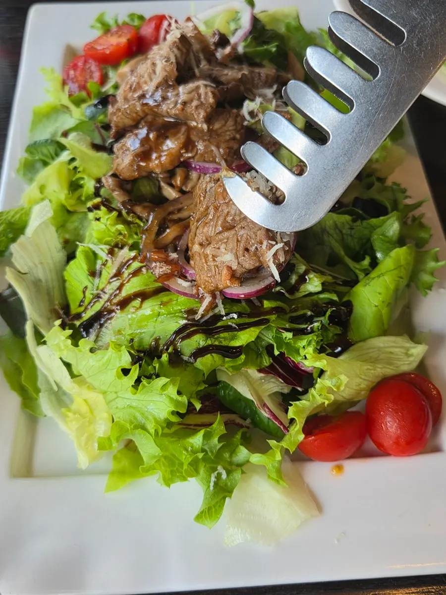 Steak salad piled high with vegetables