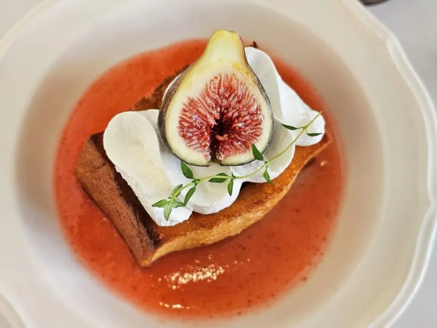 A cut piece of Oji toast topped with yogurt cream