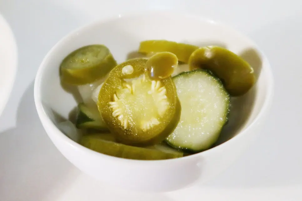 Pickles served alongside the pre-meal bread