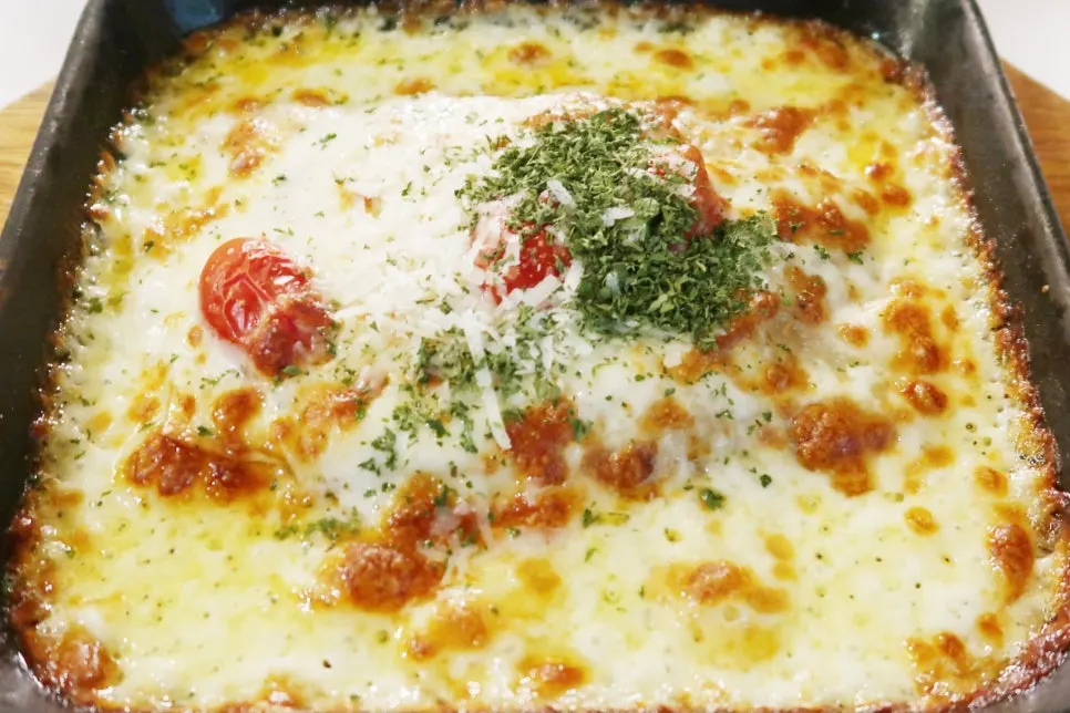 Lasagna piled high with cheese at Two Find Peter
