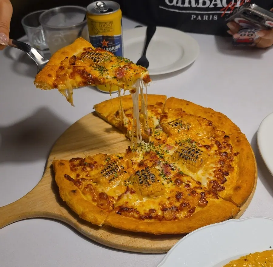 Close-up of a sliced corn pizza