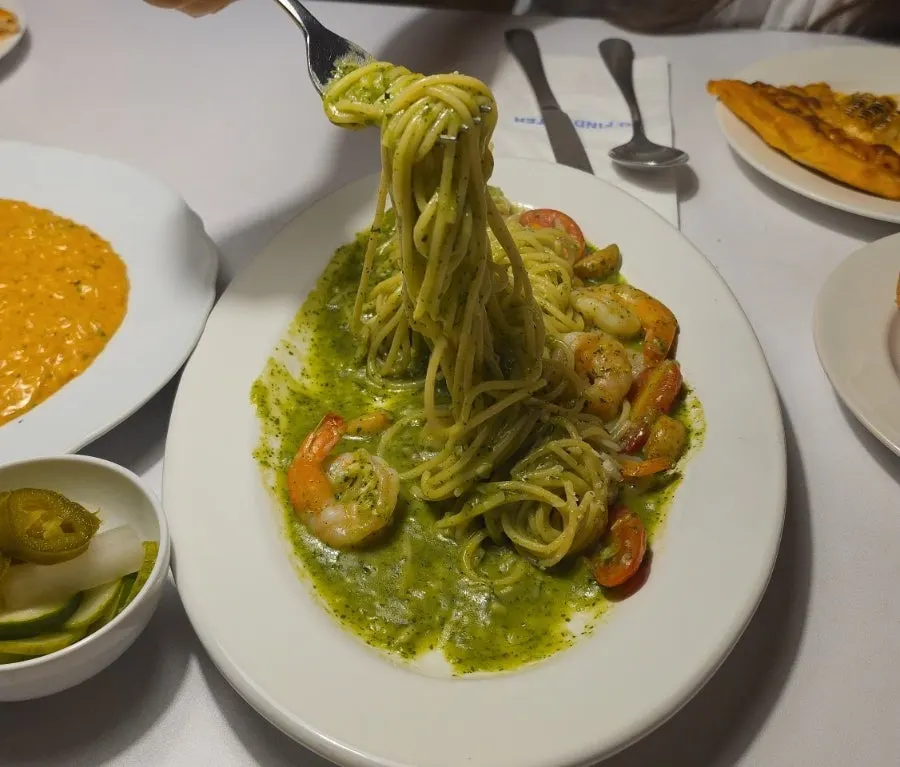 Noodles and shrimp lifted together from the oil pasta