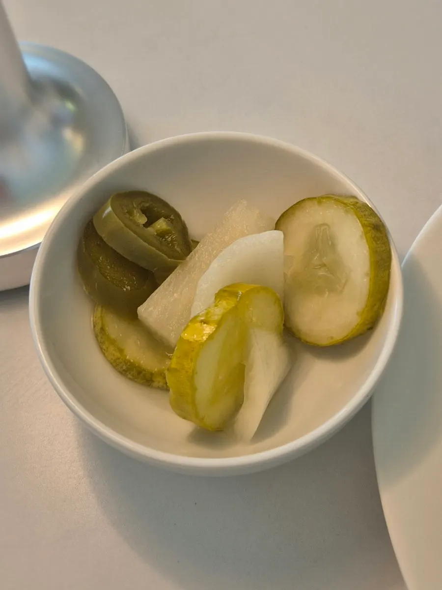 Pickles served alongside the bread