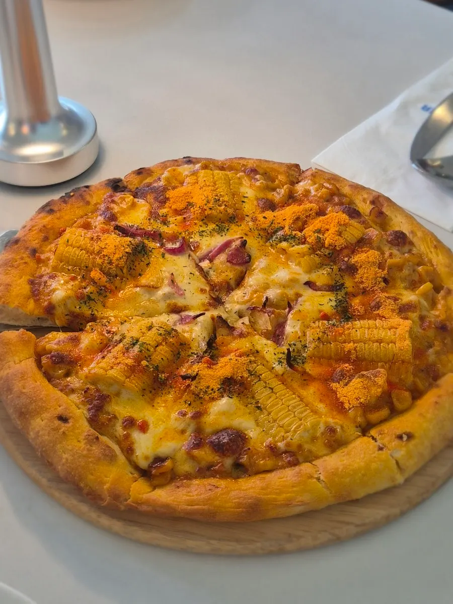 Corn pizza topped with sweet sauce corn