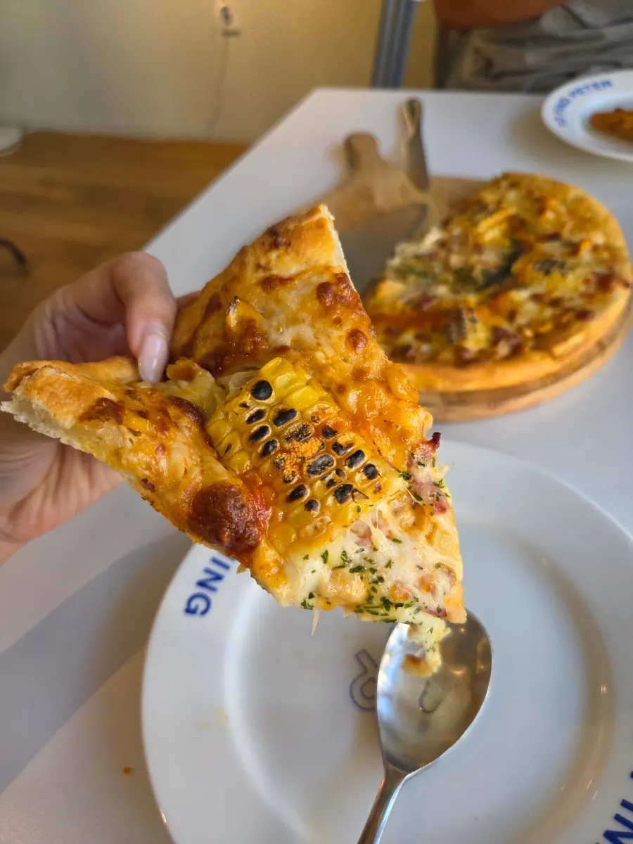 Freshly baked slice of corn pizza