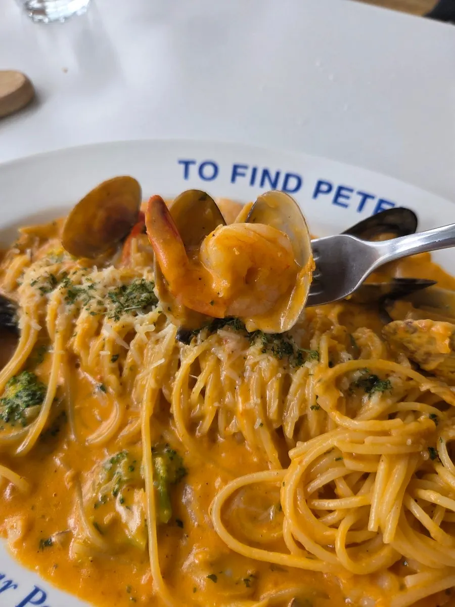 Seafood rosé pasta topped with shrimp and mussels