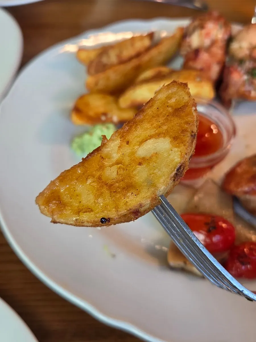 Close-up of freshly fried wedge fries