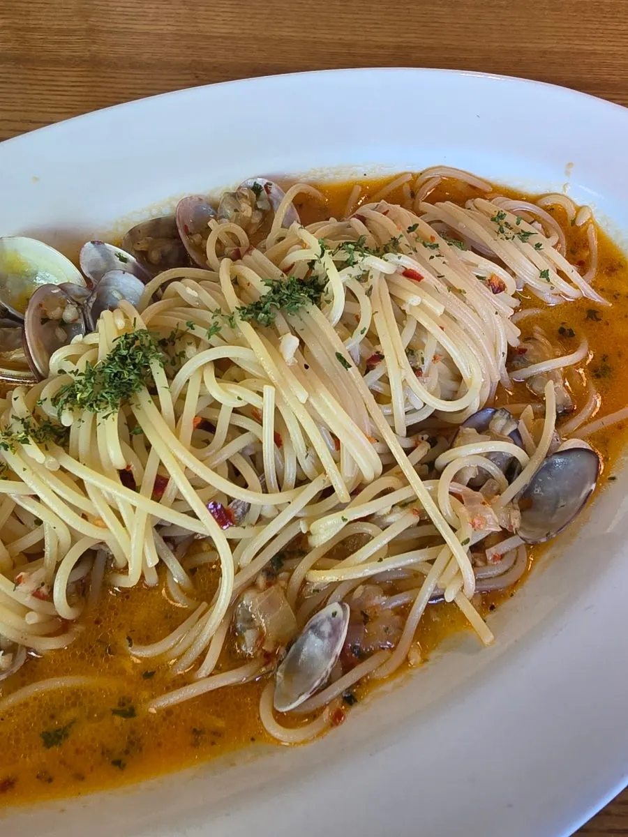 Noodles lifted from the spicy vongole oil pasta