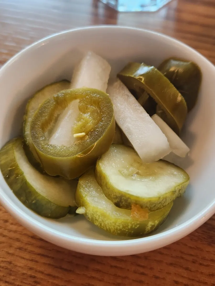 Complimentary bread and pickles served first