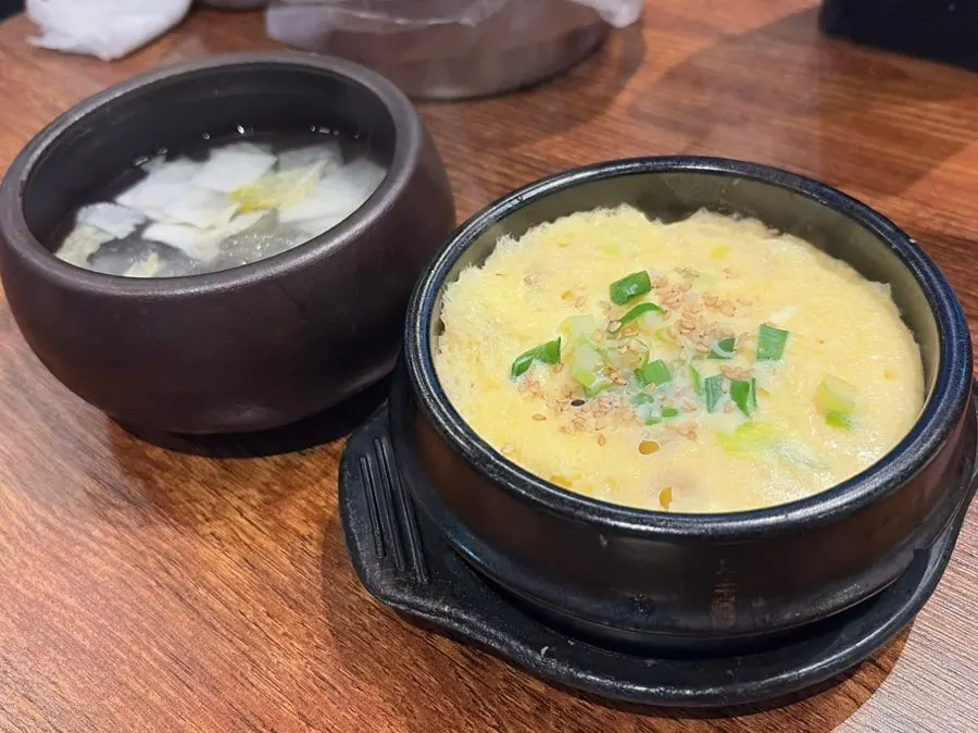 Steamed egg and dongchimi served as complimentary sides
