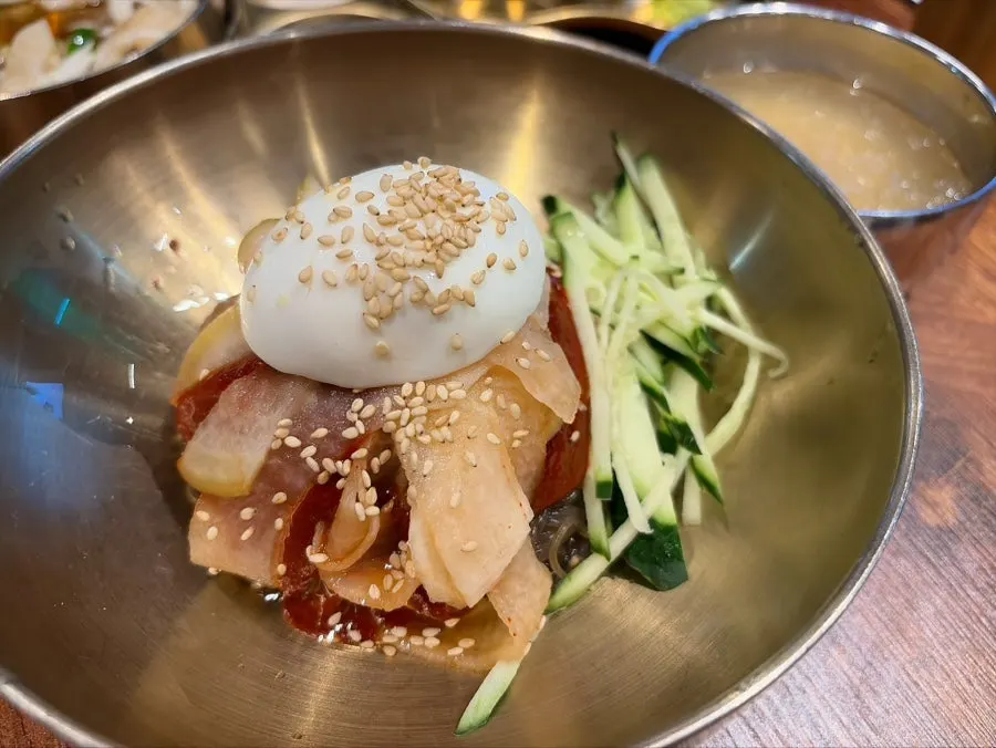 Bibim naengmyeon topped with ice shavings and garnish
